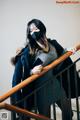 A woman wearing a face mask standing on a stairwell.