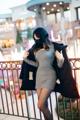 A woman wearing a face mask standing on a balcony.