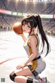 A girl holding a basketball on a basketball court.