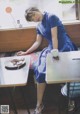 A woman sitting at a table with a plate of food.